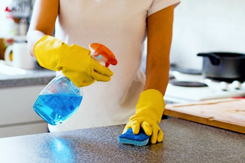 Professional oven cleaner in Uxbridge removing grease from a kitchen oven