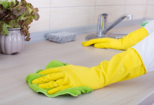 Professional home cleaner in Uxbridge tidying a bright living room